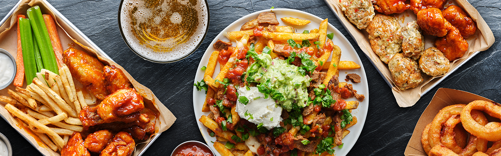 Chicken wings, fries, and onion rings. 
