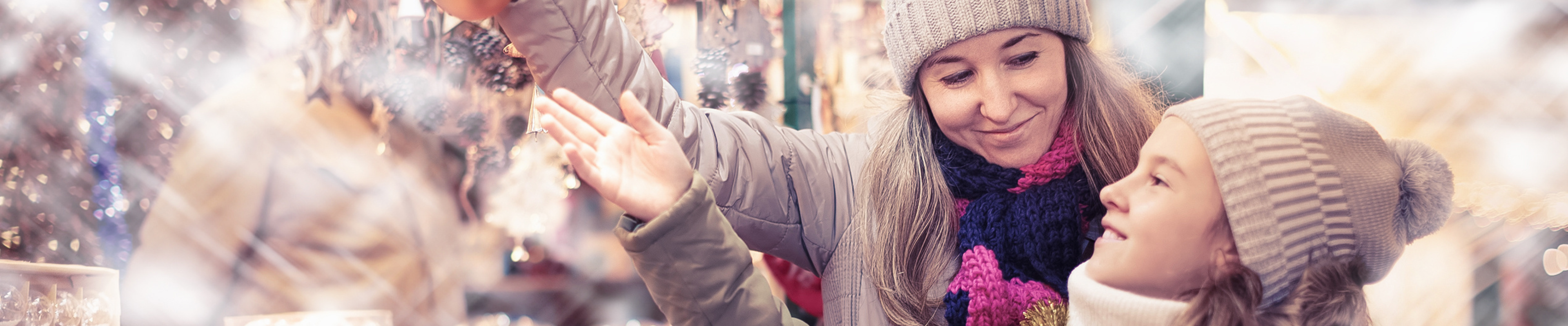 Mother and daughter looking at Holiday decorations. 