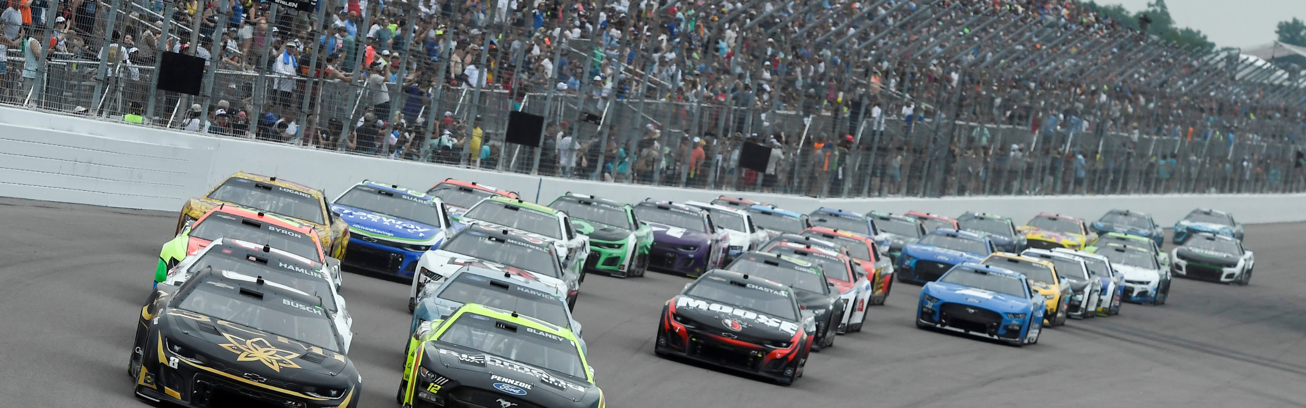 Cars racing on a race track. 
