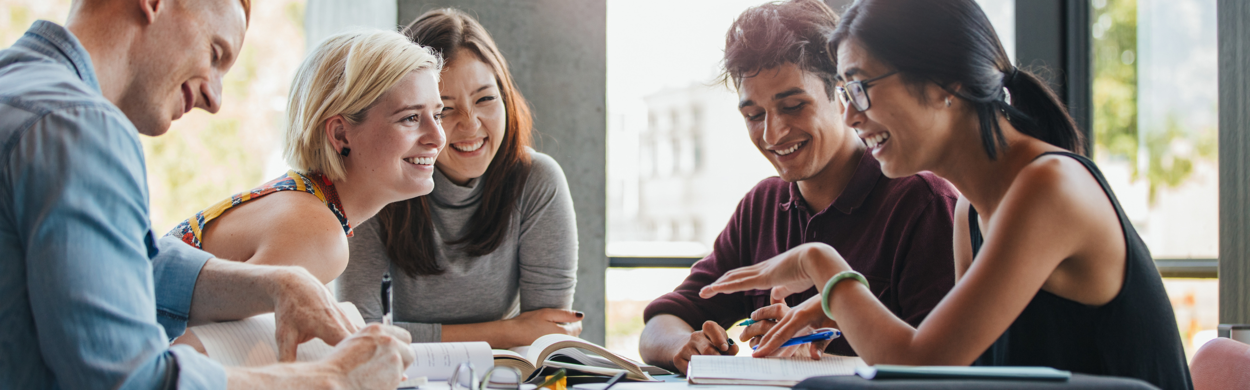 College students laughing and studying together. 