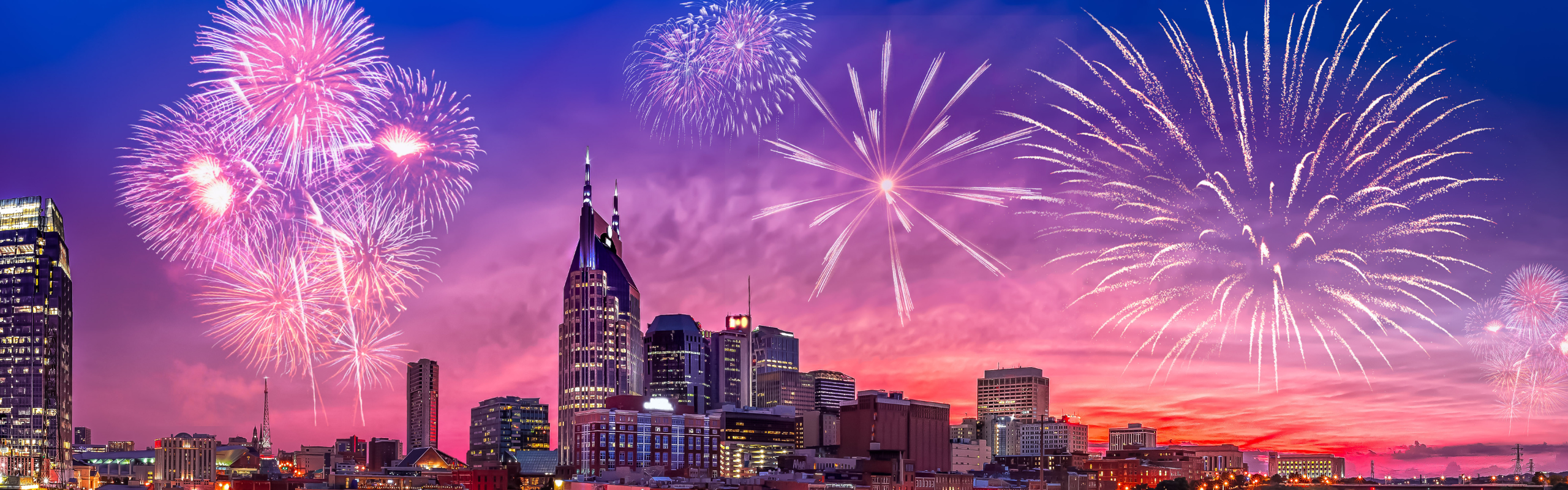 Fireworks above buildings. 