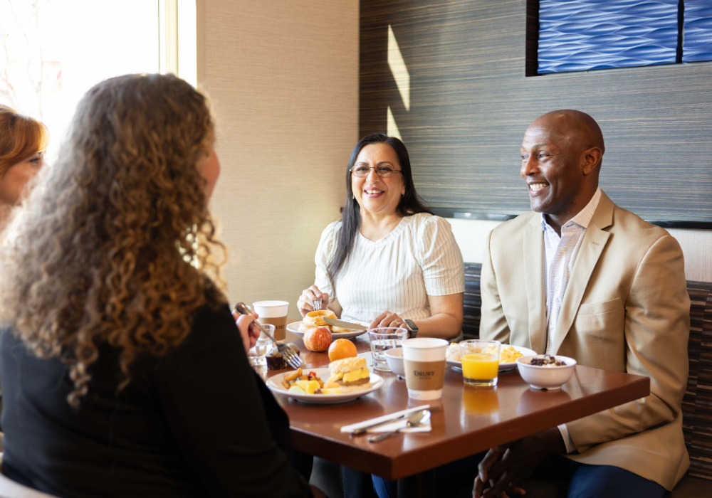 Group of Business travelers eating Hot Breakfast 
