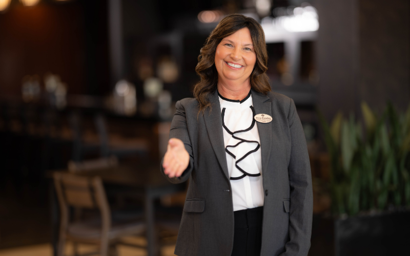 Drury employee smiling with hand held out in greeting