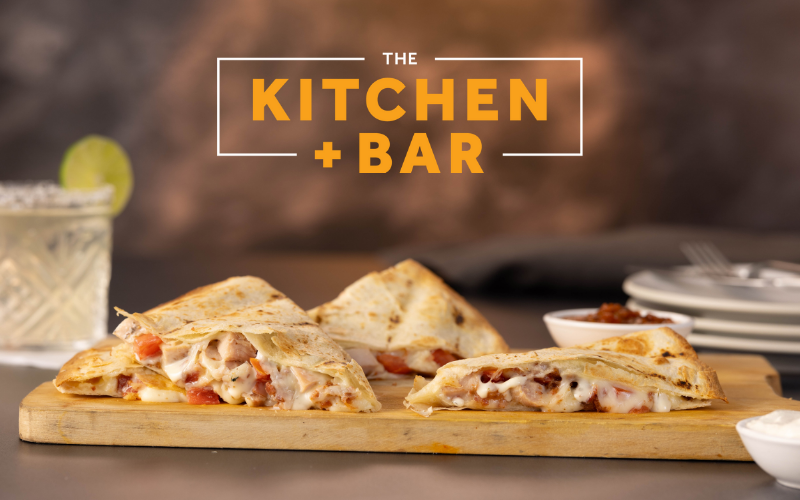 Kitchen + Bar logo with quesadilla available